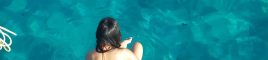 Girl sitting on the pontoon of a catamaran