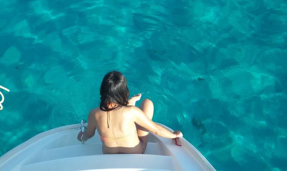 Girl sitting on the pontoon of a catamaran
