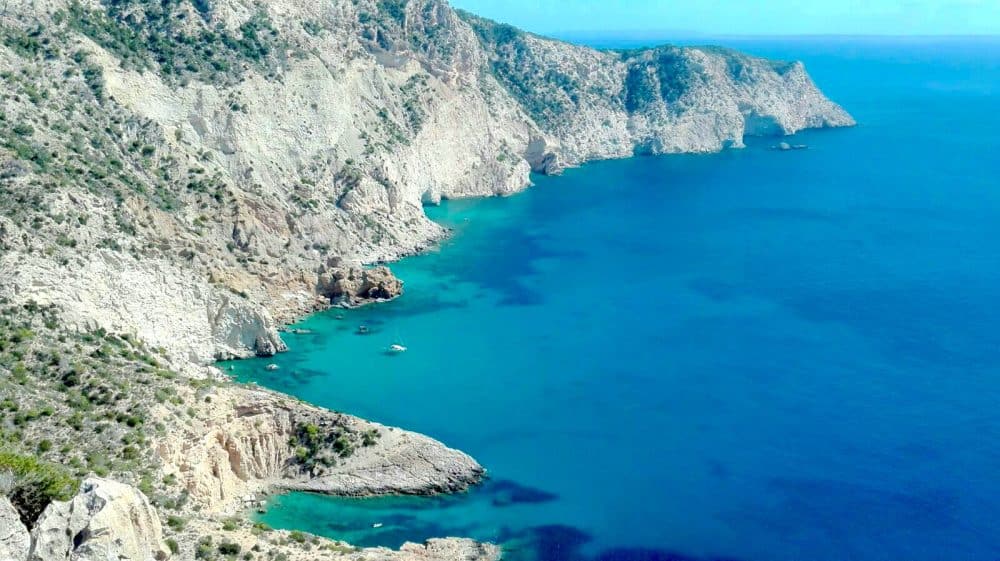 Catamaran fondeado en un espectacular acantilado de Ibiza. Muy cerca de Atlantis