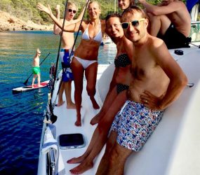 Catamaran hire Ibiza. French family Smiling on board