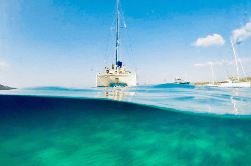 Catamaran Rental Ibiza, our catamaran anchored on crystal blue waters