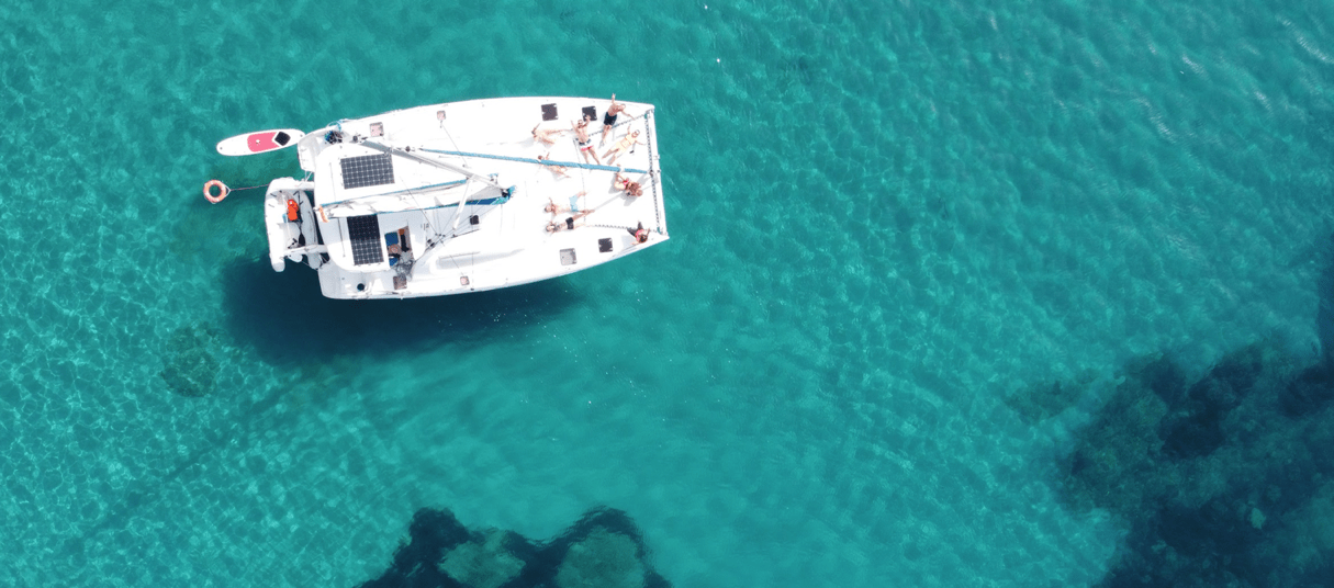 Catamaran day trip Ibiza, geronimo anchored in Cala dhort