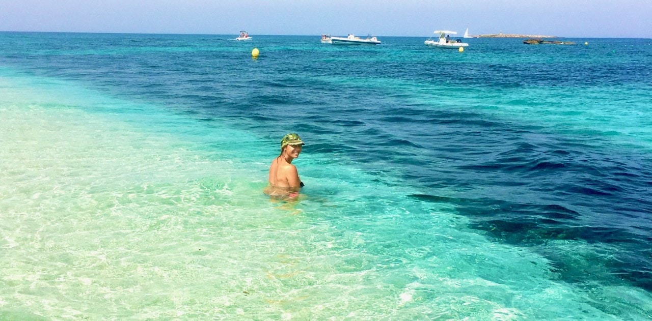 Catamaran hire Ibiza. Girl at the beach of Espalmador