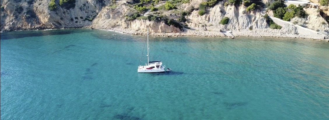 Catamaran Ibiza. Geronimo anchored on sand.