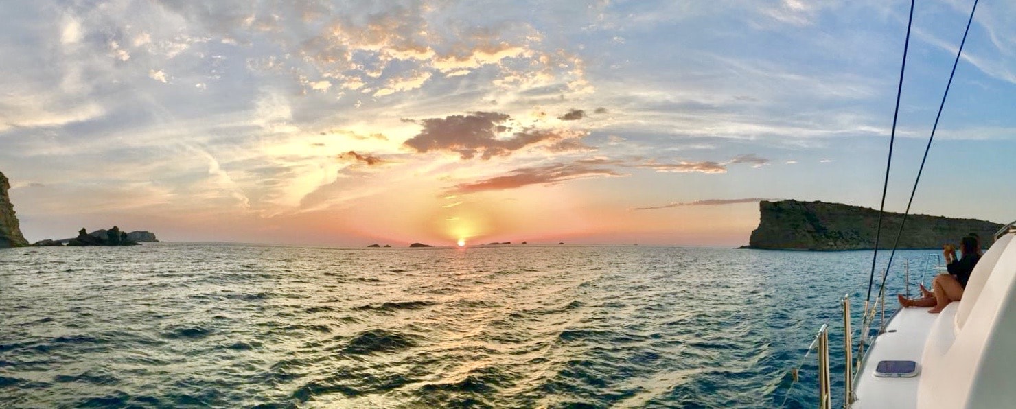 catamaran rental Ibiza, a girl on board ejoying an amazing sunset