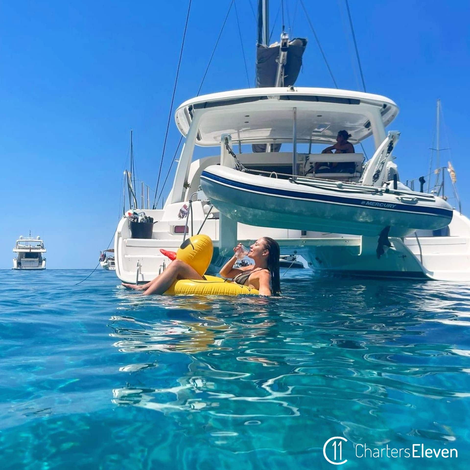 Catamaran hire in Ibiza, girl on a duck floatie