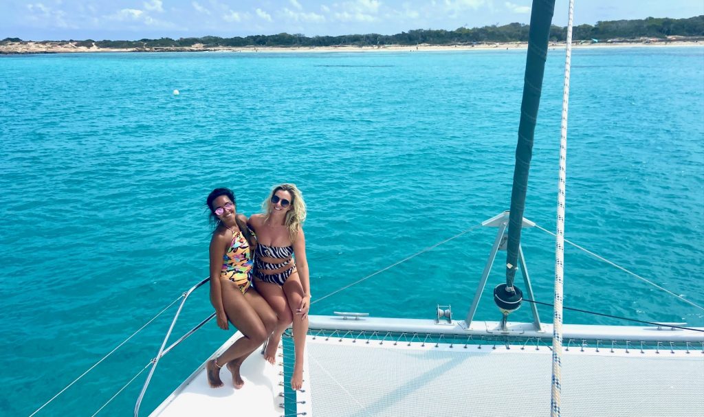Catamaran day charter Ibiza Formentera. Girls super happy getting formentera on our catamaran